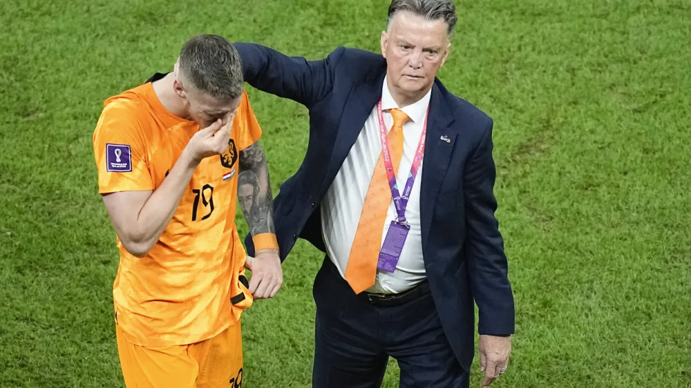 Wout Weghorst, left, is consoled by head coach Louis van Gaal of the Netherlands, at the end of the World Cup quarterfinal soccer match between the Netherlands and Argentina, at the Lusail Stadium in Lusail, Qatar, Saturday, Dec. 10, 2022. (AP Photo/Ariel Schalit)