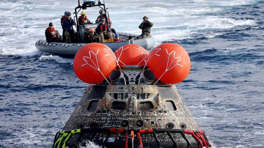 AT SEA, PACIFIC OCEAN - DECEMBER 11: NASA's Orion Capsule is drawn to the well deck of the U.S.S. Portland after it splashed down following a successful uncrewed Artemis I Moon Mission on December 11, 2022 in the Pacific Ocean off the coast of Baja California, Mexico. Mario Tama/Pool via REUTERS