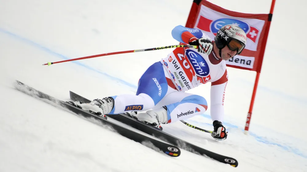 Switzerland's Beat Feuz speeds past a gate on his way to win an alpine ski, men's World Cup super-G in Val Gardena, Italy, Friday, Dec. 16, 2011. (AP Photo/Elvis Piazzi)