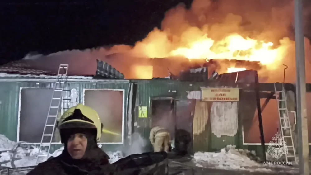 Firefighters work to extinguish a fire in an unregistered home for the elderly in the Siberian city of Kemerovo, Russia December 24, 2022. Russian Emergencies Ministry/Handout via REUTERS ATTENTION EDITORS - THIS IMAGE WAS PROVIDED BY A THIRD PARTY. NO RESALES. NO ARCHIVES. MANDATORY CREDIT.