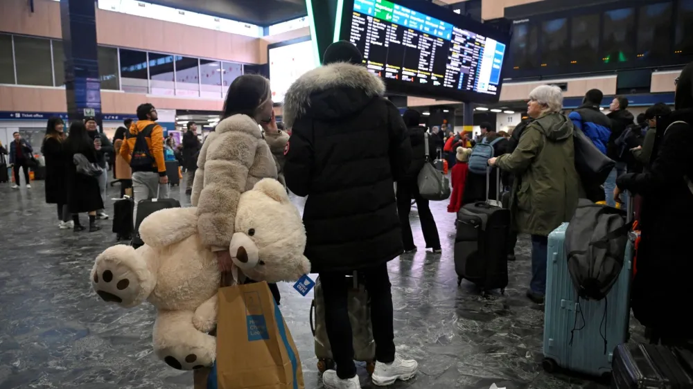 People wait at Euston station ahead of a rail workers' strike over pay and terms, on Christmas Eve in London, Britain December 24, 2022. REUTERS/Toby Melville