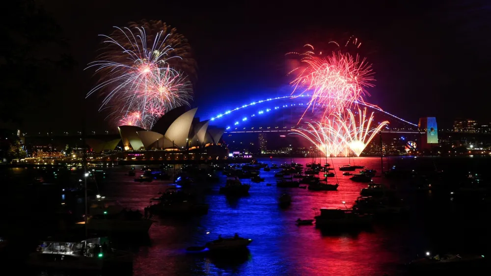 Early fireworks explode over Sydney Opera House during the New Year's Eve celebrations, in Sydney, Australia, December 31, 2022. REUTERS/Jaimi Joy