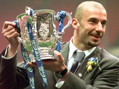 FILE - Chelsea's player and manager Gianluca Vialli celebrates with the Coca-Cola Cup trophy after his Chelsea team beat Middlesbrough 2-0 in the final at London's Wembley stadium, Sunday, March 29, 1998. Gianluca Vialli, the former Italy striker who helped both Sampdoria and Juventus win Serie A and European trophies before becoming a player-manager at Chelsea, has died on Friday, Jan. 6, 2023. He was 58. (AP Photo/Max Nash, File)