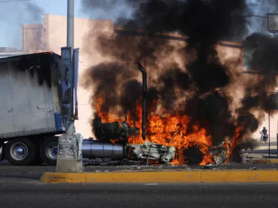 A truck burns on a street in Culiacan, Sinaloa state, Thursday Jan. 5, 2023. Mexican security forces captured Ovidio Guzmán, an alleged drug trafficker wanted by the United States and one of the sons of former Sinaloa cartel boss Joaquín "El Chapo" Guzmán, in a pre-dawn operation Thursday that set off gunfights and roadblocks across the western state's capital. (AP Photo/Martin Urista)