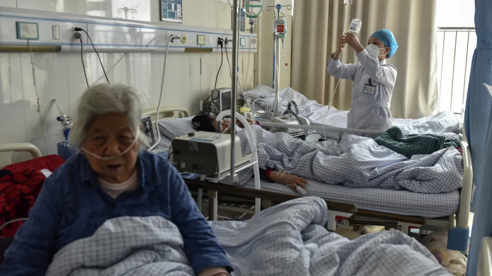 Elderly patients with COVID symptoms receive intravenous drips at the emergency ward of a hospital in Fuyang in central China's Anhui province on Jan. 4, 2023. China's healthcare authorities declined to include Pfizer's COVID-treatment drug in a national reimbursement list that would have allowed patients to get it at a cheaper price throughout the country, saying it was too expensive. (Chinatopix Via AP)