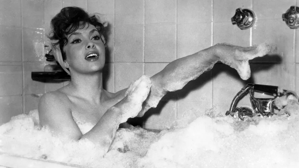 Italian actress Gina Lollobrigida takes a bubble bath in a scene of her new film called "Anna from Brooklyn", being shot at Rome's, Italy, Cinecitta studios, December 5, 1957. "Lollo" expects her first baby any day now. (AP Photo/Walter Attenni)