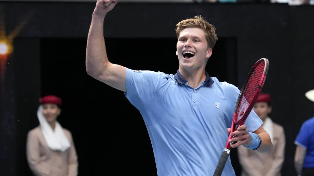 Jenson Brooksby of the U.S. celebrates after defeating Casper Ruud of Norway in their second round match at the Australian Open tennis championship in Melbourne, Australia, Thursday, Jan. 19, 2023. (AP Photo/Dita Alangkara)