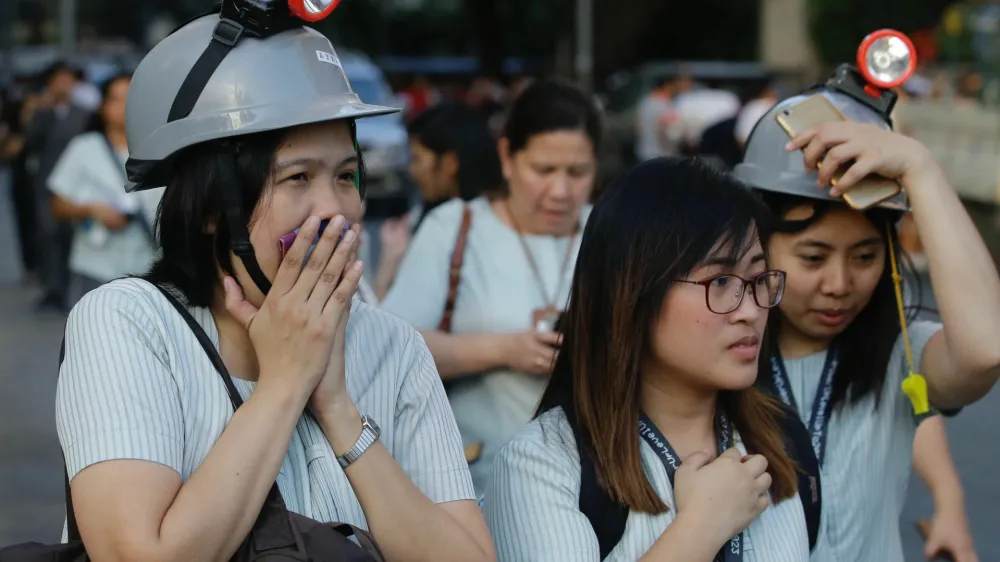 ﻿Wearing protective helmets, employees evacuate their office building following an earthquake in Manila, Philippines Monday, April 22, 2019. A strong earthquake has shaken the area around the Philippine capital, prompting thousands of people to flee to safety. There were no immediate reports of injuries or widespread damage. The U.S. Geological Survey says the magnitude 6.3 quake struck northwest of Manila near the town of Gutad on Luzon island. (AP Photo/Aaron Favila)