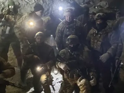 People in military uniform, claimed to be soldiers of Russian mercenary group Wagner and its head Yevgeny Prigozhin, pose for a picture believed to be in a salt mine in Soledar in the Donetsk region, Ukraine, in this handout picture released January 10, 2023. Press service of "Concord"/Handout via REUTERS ATTENTION EDITORS - THIS IMAGE WAS PROVIDED BY A THIRD PARTY. NO RESALES. NO ARCHIVES. MANDATORY CREDIT.