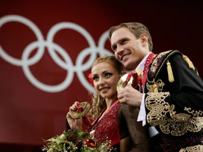 FILE PHOTO: Figure skating - Gold medal winners Tatiana Navka and Roman Kostomarov from Russia pose on the podium after the ice dancing competition at the 2006 Turing Winter Olympics, Italy February 20, 2006. REUTERS/Jerry Lampen/File Photo
