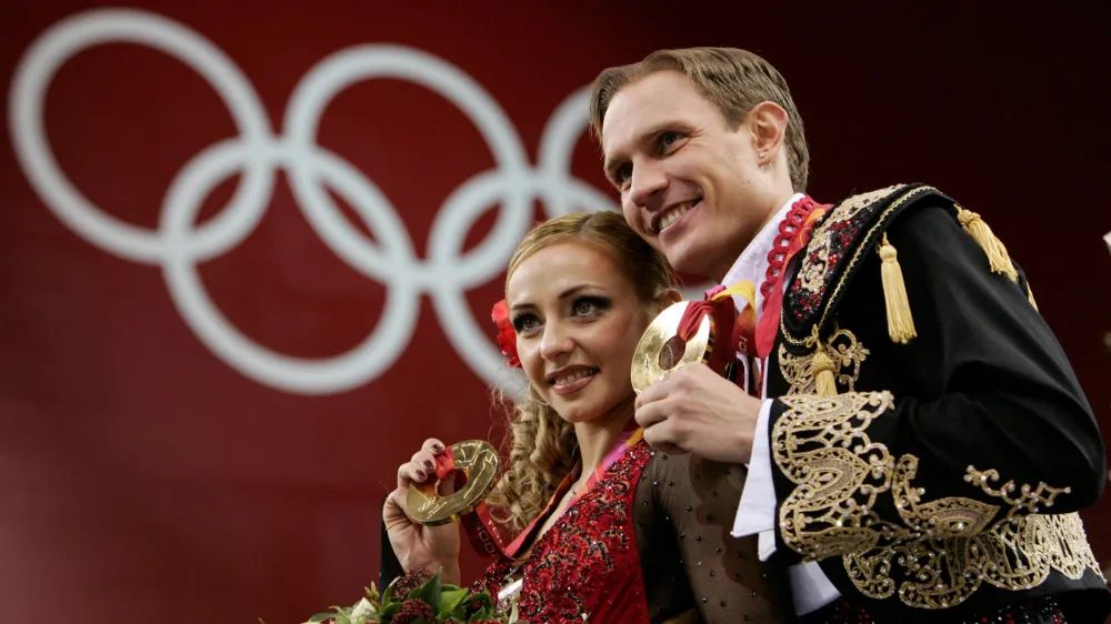 FILE PHOTO: Figure skating - Gold medal winners Tatiana Navka and Roman Kostomarov from Russia pose on the podium after the ice dancing competition at the 2006 Turing Winter Olympics, Italy February 20, 2006. REUTERS/Jerry Lampen/File Photo
