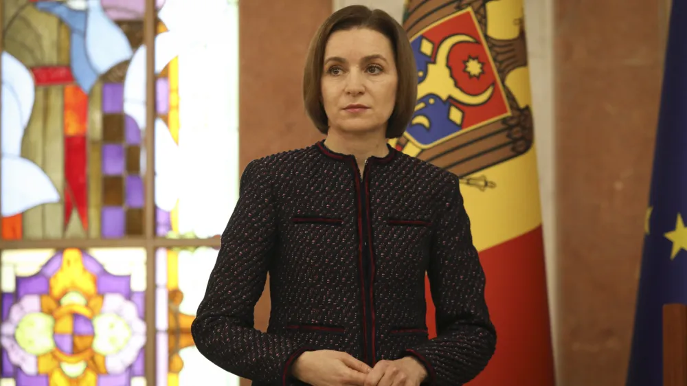 Moldovan President Maia Sandu pauses as Prime Minister designate Dorin Recean speaks after she appointed him to form a new government in Chisinau, Moldova, Friday, Feb 10, 2023. Moldova's government collapsed Friday as pro-Western Prime Minister Natalia Gavrilita resigned, adding to a series of crises that have gripped the small nation since Russia invaded its neighbor, Ukraine. (AP Photo/Aurel Obreja)