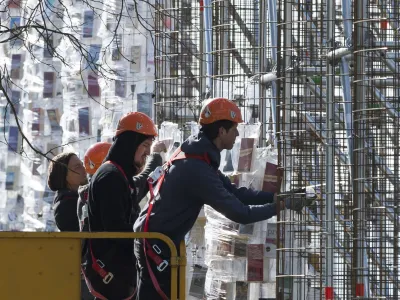 ﻿Workers hang books wrapped in plastic on the steel construction frame for the documenta art work "The Parthenon of Books' in Kassel, Germany, 24 April 2017. The reconstruction of the Parthenon temple of the Argentinian artist Marta Minujin is one of the largest projects of the Documenta. The Documenta will take place in Kassel from the 10th of June to the 17th of September 2017. Photo by: Swen Pf'rtner/picture-alliance/dpa/AP Images