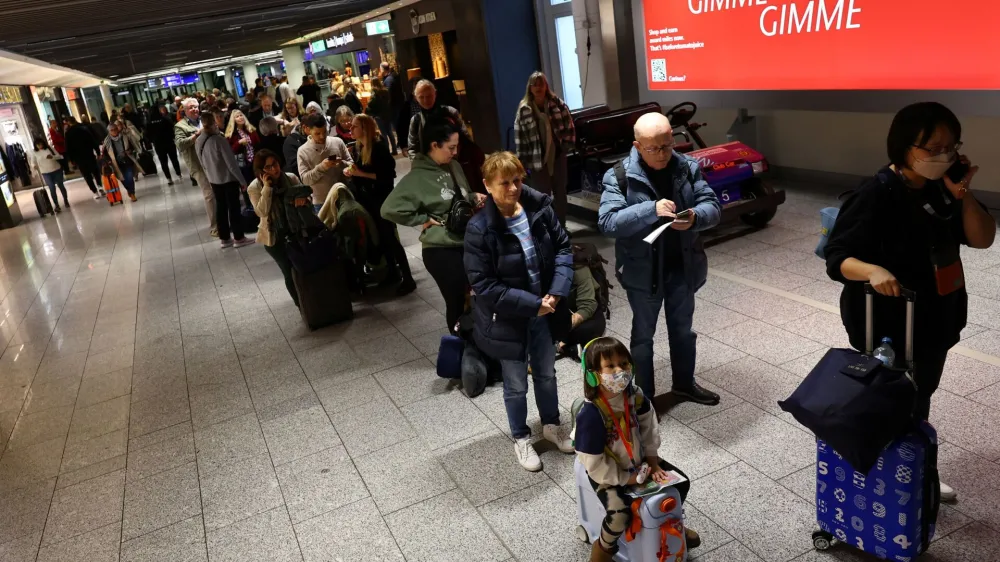 Passengers stand in line after an IT fault at Germany?s Lufthansa causes massive flight delays and disruptions in Frankfurt, Germany, February 15, 2023.   REUTERS/Kai Pfaffenbach