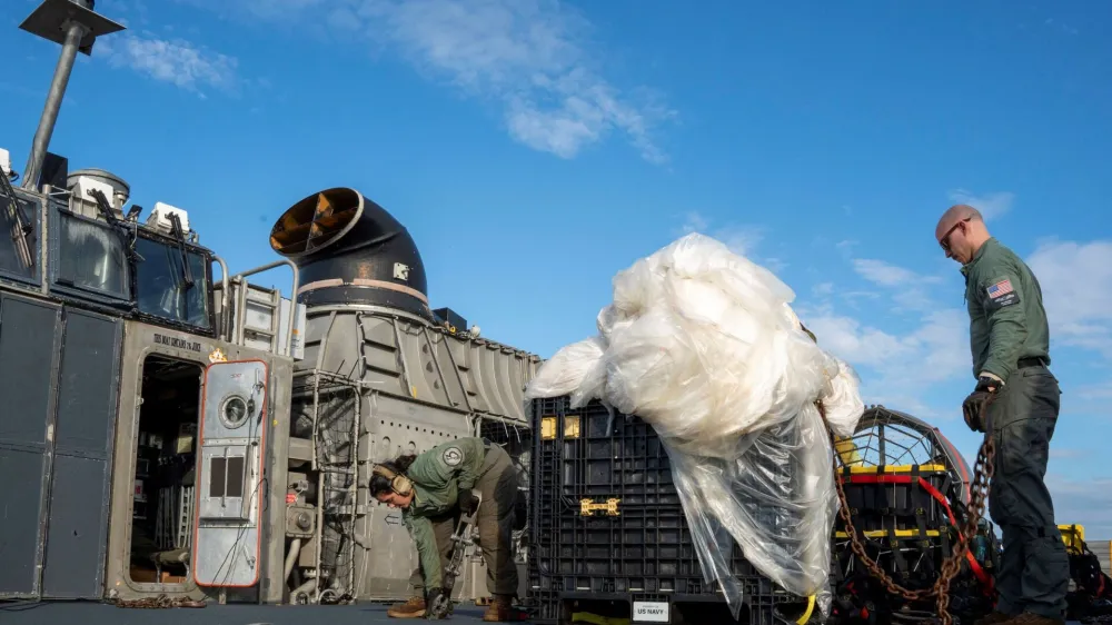 U.S. Navy sailors assigned to Assault Craft Unit 4 prepare material recovered in the Atlantic Ocean from a high-altitude Chinese balloon shot down by the U.S. Air Force off the coast of South Carolina for transport from a ship docked at Virginia Beach, Virginia to federal agents at Joint Expeditionary Base Little Creek on February 10, 2023 in this image released by the U.S. Navy in Washington, U.S. February 13, 2023. Petty Officer 1st Class Kris Lindstrom/U.S. Navy/Handout via Reuters THIS IMAGE HAS BEEN SUPPLIED BY A THIRD PARTY.
