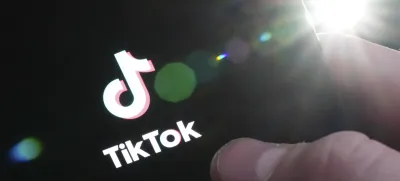 The TikTok startup page is displayed on an iPhone in Ottawa, Ontario, Monday, Feb. 27, 2023. The federal government is banning TikTok from its mobile devices just days after federal and provincial privacy commissioners launched an investigation into the social media platform. (Sean Kilpatrick/The Canadian Press via AP)