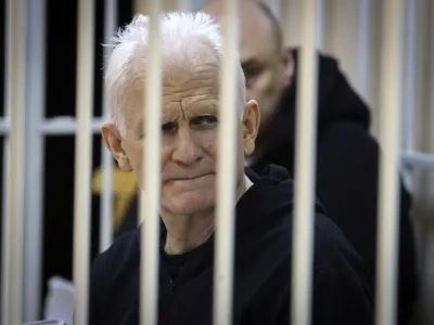 FILE - Ales Bialiatski, the head of Belarusian Vyasna rights group, sits in a defendants' cage during a court session in Minsk, Belarus, on Thursday Jan. 5, 2023. A Belarusian court has sentenced Ales Bialiatski, Belarus' top human rights advocate and one of the winners of the 2022 Nobel Peace Prize, to 10 years in prison. Bialiatski and three other top figures of the Viasna human rights center he founded were convicted of financing anti-government protests. (Vitaly Pivovarchyk/BelTA Pool Photo via AP, File)
