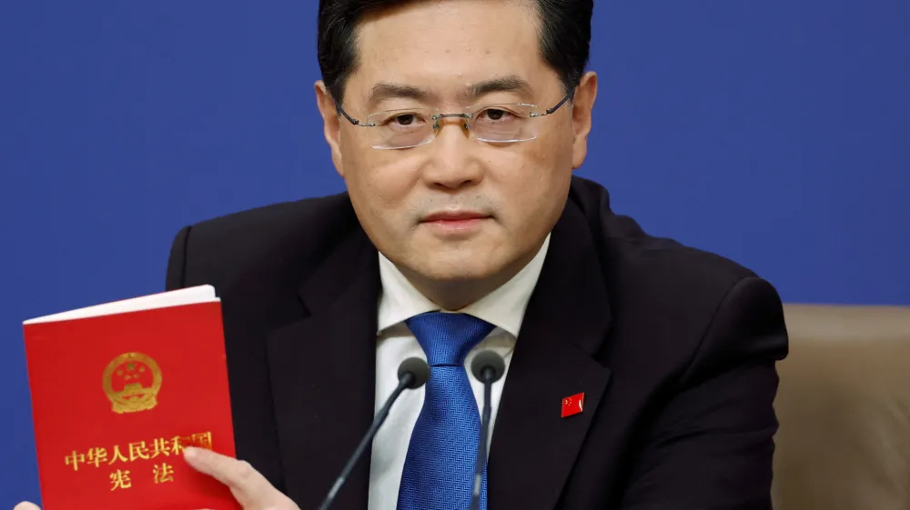Chinese Foreign Minister Qin Gang holds a book of China's Constitution at a news conference on the sidelines of the National People's Congress (NPC) in Beijing, China March 7, 2023. REUTERS/Thomas Peter