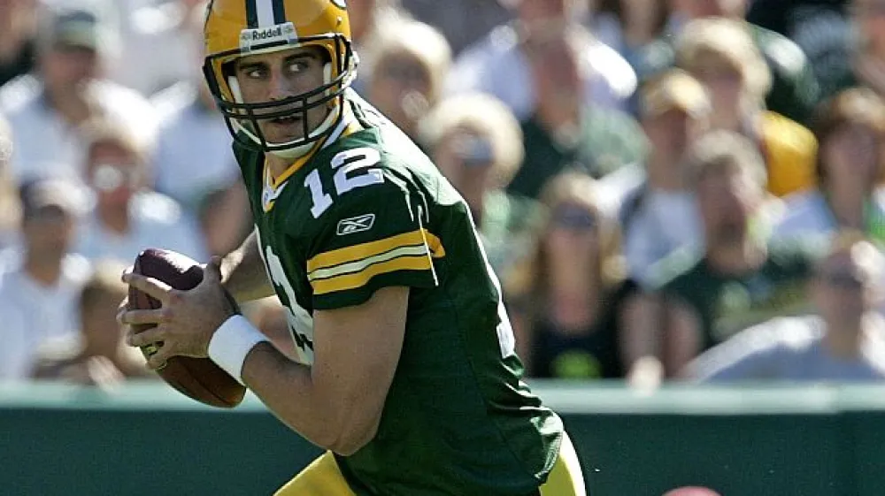 Green Bay Packers quarterback Aaron Rodgers rolls out to pass during the second quarter of an NFL preseason football game against the Tennessee Titans Friday, Sept. 1, 2006, in Green Bay, Wis. (AP Photo/ Mike Roemer)