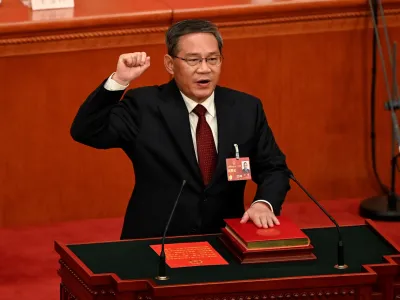China's newly-elected Premier Li Qiang takes an oath after being elected during the fourth plenary session of the National People's Congress (NPC) at the Great Hall of the People in Beijing, China on March 11, 2023.   GREG BAKER/Pool via REUTERS