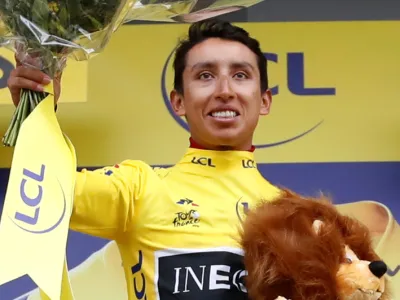 ﻿Cycling - Tour de France - The 126.5-km Stage 19 from Saint-Jean-de-Maurienne to Tignes - July 26, 2019 - Team INEOS rider Egan Bernal of Colombia celebrates on the podium, wearing the overall leader's yellow jersey. REUTERS/Christian Hartmann