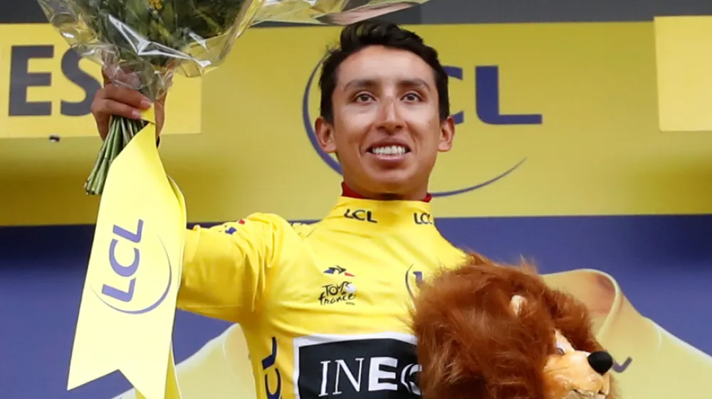 ﻿Cycling - Tour de France - The 126.5-km Stage 19 from Saint-Jean-de-Maurienne to Tignes - July 26, 2019 - Team INEOS rider Egan Bernal of Colombia celebrates on the podium, wearing the overall leader's yellow jersey. REUTERS/Christian Hartmann