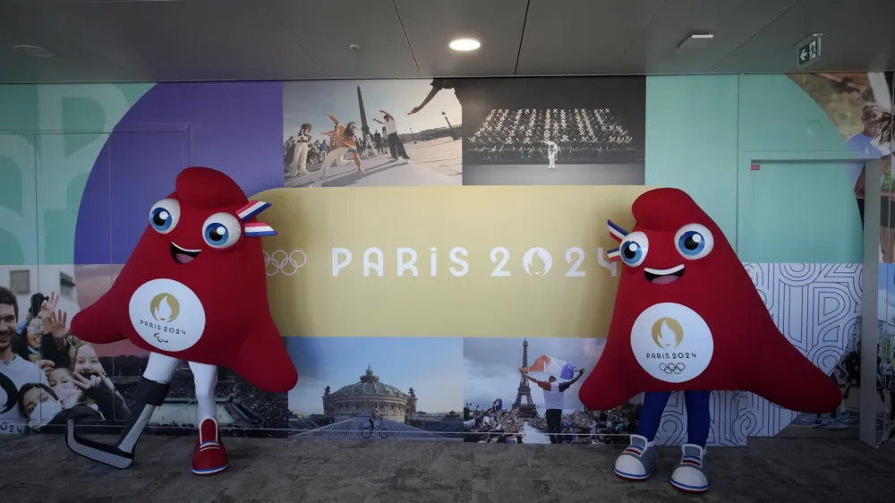 Mascots of the 2024 Paris Olympic Games, right, and Paralympics Games, a Phrygian cap, pose during a preview in Saint Denis, outside Paris, Thursday, Nov. 10, 2022. The soft bright red cap, also known as a liberty cap, is an updated version of a conical hat worn in antiquity in places such as Persia, the Balkans, Thrace, Dacia and Phrygia, where the name originates, in modern day Turkey. It later became a symbol of the pursuit of liberty in the French Revolution and is still worn by the figure of Marianne, the national personification of France since that time. (AP Photo/Christophe Ena)