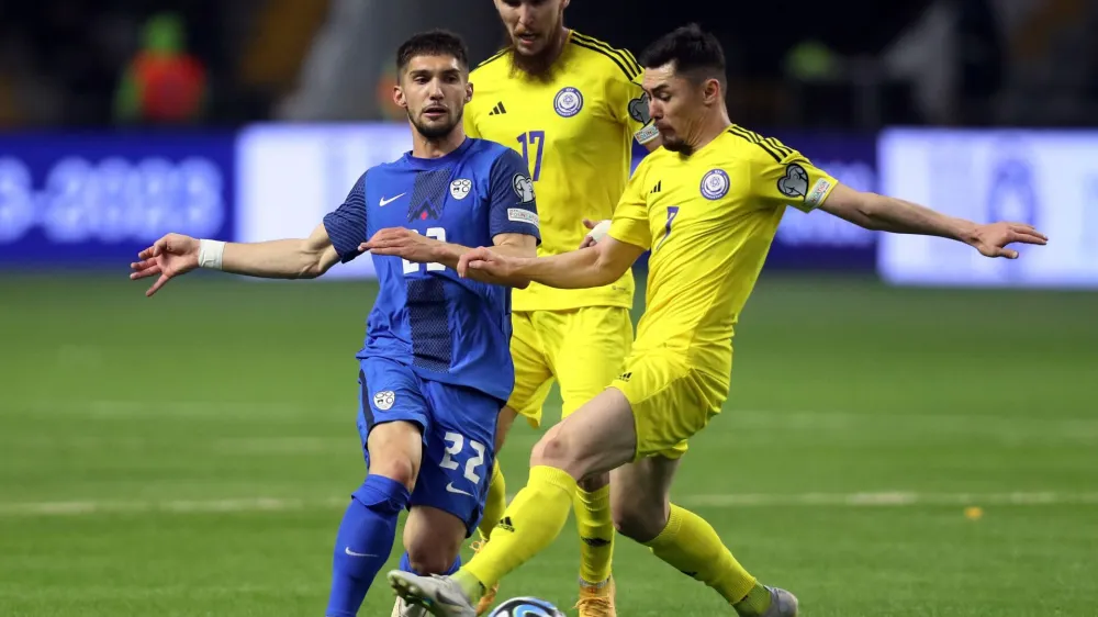 Soccer Football - UEFA Euro 2024 Qualifiers - Group H - Kazakhstan v Slovenia - Astana Arena, Astana, Kazakhstan - March 23, 2023 Slovenia's Adam Gnezda Cerin in action with Kazakhstan's Aslan Darabayev and Abat Aimbetov during the match REUTERS/Pavel Mikheyev