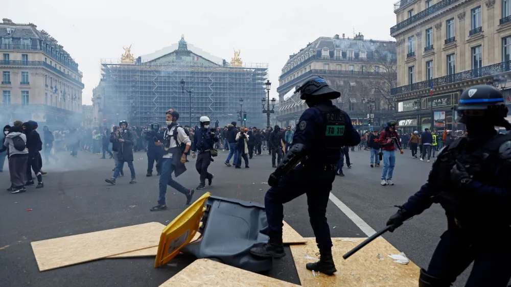 French riot police face off with protesters in front of the Opera Garnier during a demonstration as part of the ninth day of nationwide strikes and protests against French government's pension reform, in Paris, France, March 23, 2023. REUTERS/Gonzalo Fuentes