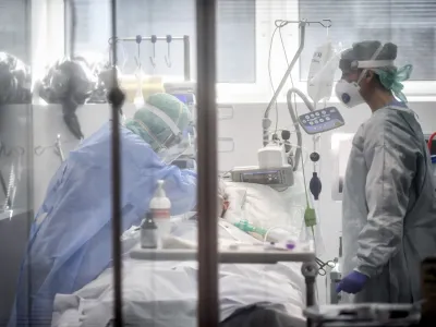 ﻿FILE - In this Thursday, March 19, 2020, file photo, medical personnel work in the intensive care unit of a hospital in Brescia, Italy. World War II references are now heard daily, not because another momentous 75th anniversary, Victory in Europe Day approaches in May but because of the coronavirus. (Claudio Furlan/LaPresse via AP, File)