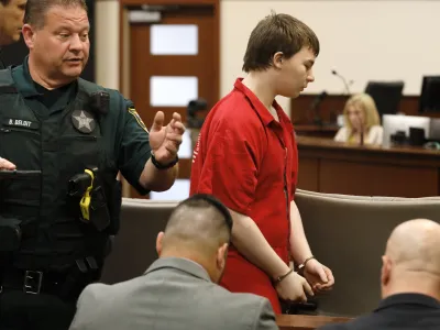 Aiden Fucci is led into the courtroom start his sentencing hearing, Friday, March 24, 2023. in St. Augustine, Fla. A Florida judge sentenced the 16-year-old Florida boy to life in prison on Friday for fatally stabbing a 13-year-old classmate on Mother's Day in 2021. Fucci, who pleaded guilty just before his trial was set to start in February, was not eligible for the death penalty. (Bob Self/The Florida Times-Union via AP)