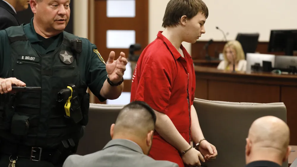Aiden Fucci is led into the courtroom start his sentencing hearing, Friday, March 24, 2023. in St. Augustine, Fla. A Florida judge sentenced the 16-year-old Florida boy to life in prison on Friday for fatally stabbing a 13-year-old classmate on Mother's Day in 2021. Fucci, who pleaded guilty just before his trial was set to start in February, was not eligible for the death penalty. (Bob Self/The Florida Times-Union via AP)