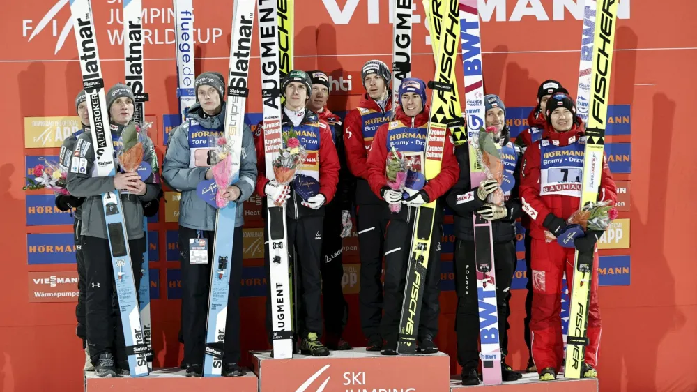 Nordic Skiing - FIS Nordic World Cup Lahti Ski Games - Lahti, Finland - March 25, 2023 Team Austria celebrate on the podium after winning the men's HS130 ski jumping alongside Team Slovenia and third-placed team Poland Antti Hamalainen/Lehtikuva via REUTERS ATTENTION EDITORS - THIS IMAGE WAS PROVIDED BY A THIRD PARTY. NO THIRD PARTY SALES. NOT FOR USE BY REUTERS THIRD PARTY DISTRIBUTORS. FINLAND OUT. NO COMMERCIAL OR EDITORIAL SALES IN FINLAND.