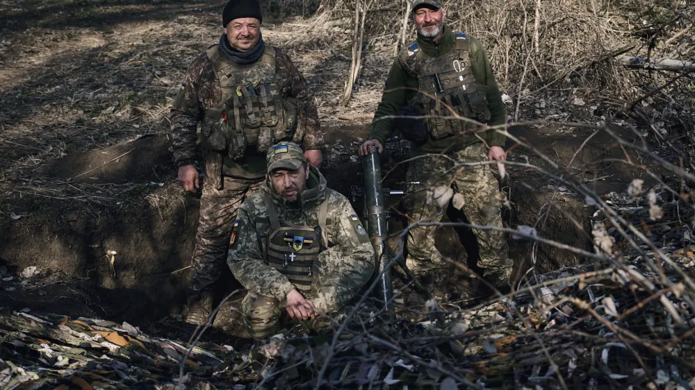 Ukrainian soldiers of the 28th brigade gather in a trench near Russian positions close to Bakhmut, Donetsk region, Ukraine, Monday, March 27, 2023. (AP Photo/Libkos)
