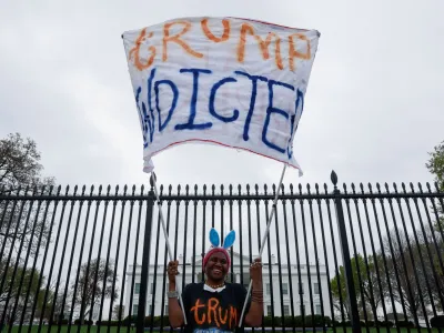 Nadine Seiler holds a "Trump Indicted" sign in front of the White House after former U.S. President Donald Trump's indictment by a Manhattan grand jury following a probe into hush money paid to porn star Stormy Daniels, in Washington, U.S. March 31, 2023. REUTERS/Jonathan Ernst