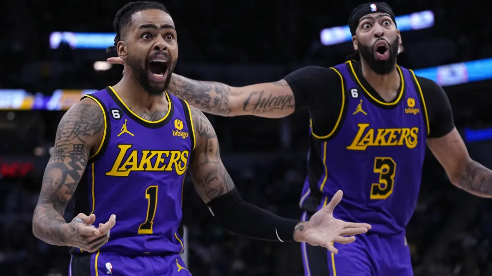 Los Angeles Lakers guard D'Angelo Russell (1) and forward Anthony Davis (3) react to a call during the second half of the team's NBA basketball game against the Minnesota Timberwolves, Friday, March 31, 2023, in Minneapolis. (AP Photo/Abbie Parr)