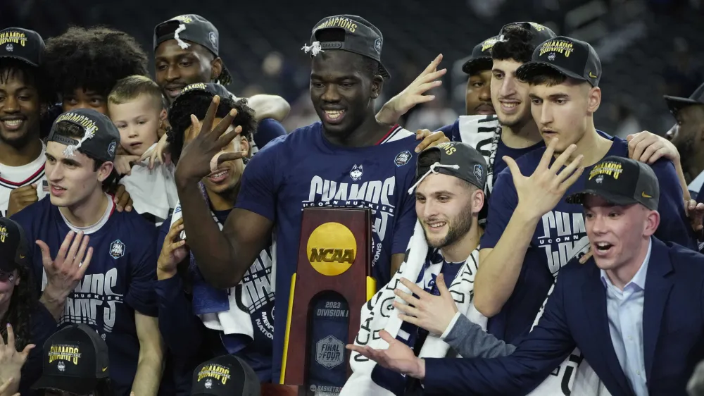 Apr 3, 2023; Houston, TX, USA; Connecticut Huskies players celebrate after defeating the San Diego State Aztecs in the national championship game of the 2023 NCAA Tournament at NRG Stadium. Mandatory Credit: Bob Donnan-USA TODAY Sports