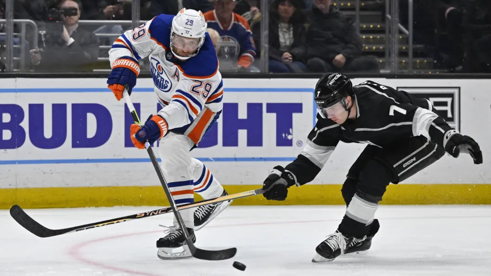 Apr 4, 2023; Los Angeles, California, USA; Los Angeles Kings Tobias Bjornfot (7) defends a shot on goal by Edmonton Oilers center Leon Draisaitl (29) in the third period at Crypto.com Arena. Mandatory Credit: Jayne Kamin-Oncea-USA TODAY Sports