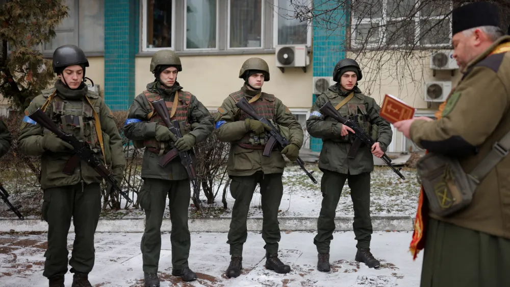 Military Chaplain Nikolay Medynsky reads a prayer before blessing Ukrainian servicemen and their weapons before they go into battle, as Russia's attack on the Ukraine continues, in Kyiv, Ukraine, March 13, 2022. REUTERS/Thomas Peter