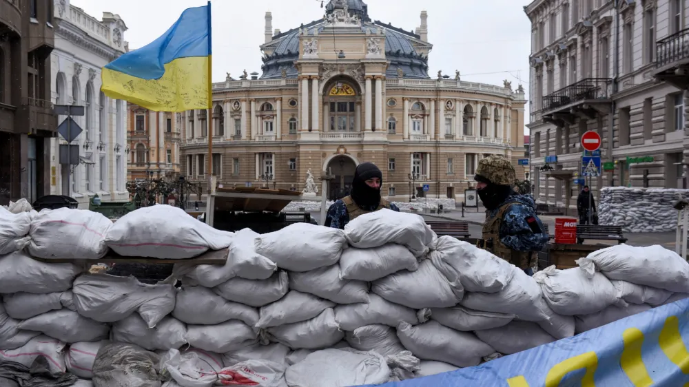 Soldiers stand guard behind a barricade, with the Odessa National Academic Opera and Ballet Theatre seen in the background, amid Russia's invasion of Ukraine, in Odessa, Ukraine, March 10, 2022. REUTERS/Alexandros Avramidis