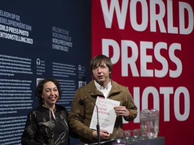 World Press Photo of the Year award winner, Associated Press photographer Evgeniy Maloletka, right, receives the diploma from Joumana El Zein Khoury, executive director of the World Press Photo Foundation, left, for his winning image of a pregnant woman being carried through the wreckage of a maternity hospital after a Russian military strike in Mariupol, Ukraine, during a press conference announcing the winners in Amsterdam, Netherlands, Thursday, April 20, 2023. (AP Photo/Peter Dejong)