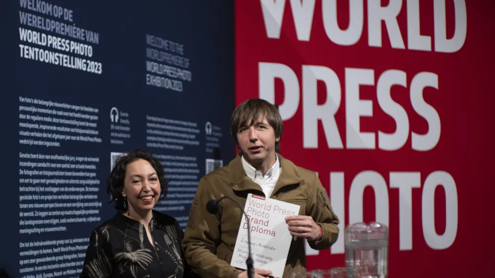 World Press Photo of the Year award winner, Associated Press photographer Evgeniy Maloletka, right, receives the diploma from Joumana El Zein Khoury, executive director of the World Press Photo Foundation, left, for his winning image of a pregnant woman being carried through the wreckage of a maternity hospital after a Russian military strike in Mariupol, Ukraine, during a press conference announcing the winners in Amsterdam, Netherlands, Thursday, April 20, 2023. (AP Photo/Peter Dejong)