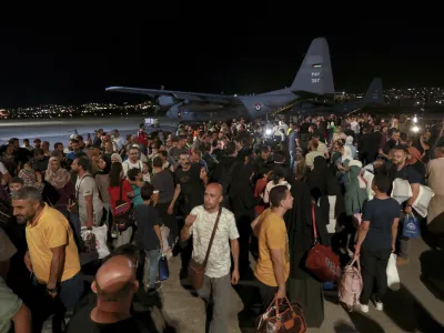 Jordanians evacuated from Sudan arrive at a military airport in Amman, Jordan, Monday, April 24, 2023. (AP Photo/Raad Adayleh)