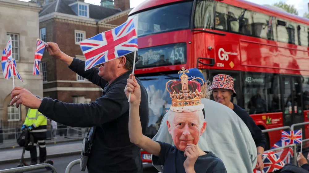 Well-wishers gather along the path that Britain's King Charles and Queen Consort Camilla will travel during the procession marking their coronation along the main streets of London, Britain, May 5, 2023. REUTERS/Violeta Santos Moura