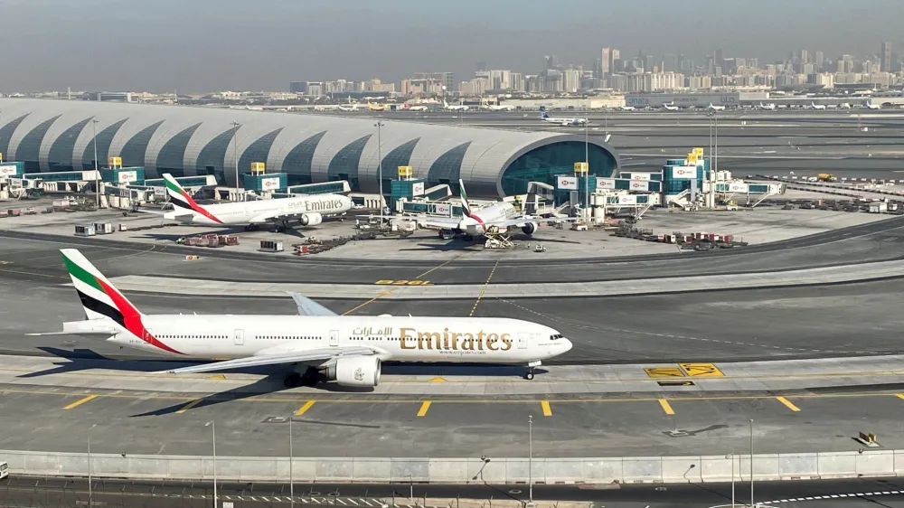 FILE PHOTO: Emirates airliners are seen on the tarmac in a general view of Dubai International Airport in Dubai, United Arab Emirates January 13, 2021. Picture taken through a window. REUTERS/Abdel Hadi Ramahi//File Photo