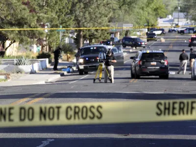 Investigators work along a residential street following a deadly shooting Monday, May 15, 2023, in Farmington, N.M. Authorities said an 18-year-old opened fire in the northwestern New Mexico community, killing multiple people and injuring others, before law enforcement fatally shot the suspect. (AP Photo/Susan Montoya Bryan)