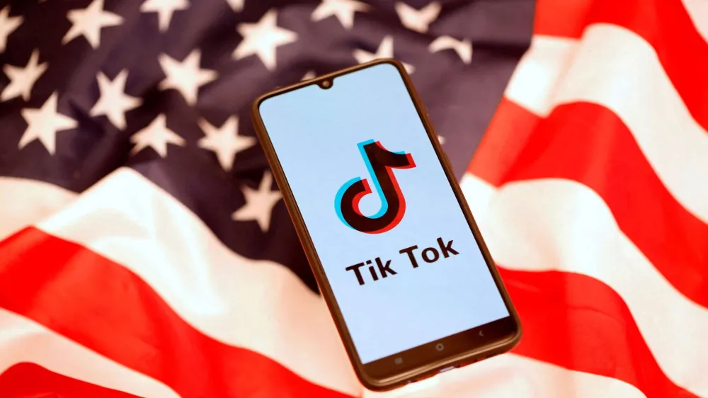FILE PHOTO: FTikTok logo is displayed on the smartphone while standing on the U.S. flag in this illustration picture taken, November 8, 2019. REUTERS/Dado Ruvic/File Photo