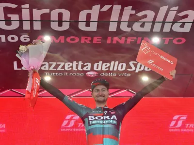 Cycling - Giro d'Italia - Stage 14 - Sierre to Cassano Magnago - Italy - May 20, 2023 BORA – hansgrohe's Nico Denz celebrates on the podium after winning stage 14 REUTERS/Jennifer Lorenzini