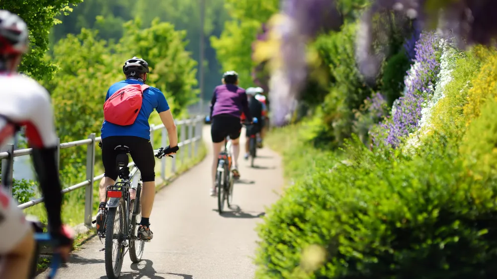 SWITZERLAND - MAY 11, 2018:Sportive middle age man cycling in sunny park in hot summer day. Nice sport for active people. Healthy lifestyle.