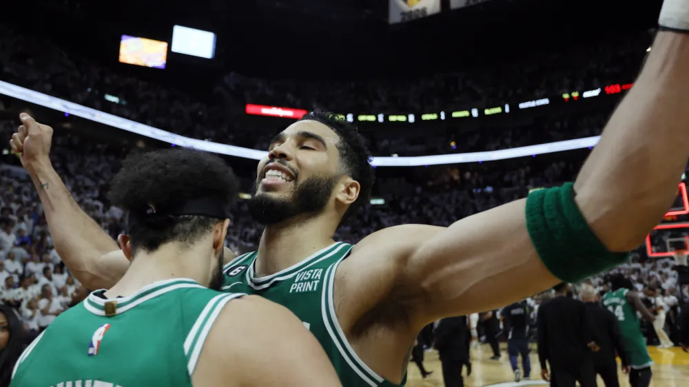 May 27, 2023; Miami, Florida, USA; Boston Celtics guard Derrick White (9) celebrates with forward Jayson Tatum (0) after defeating the Miami Heat in game six of the Eastern Conference Finals for the 2023 NBA playoffs at Kaseya Center. Mandatory Credit: Sam Navarro-USA TODAY Sports